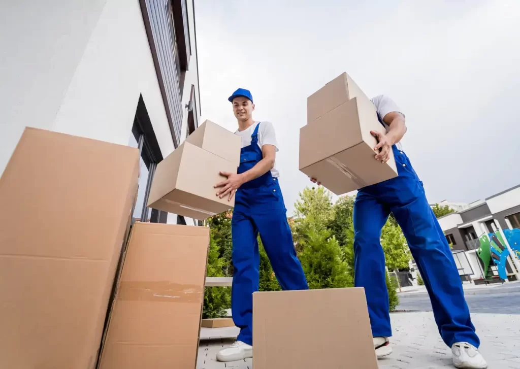2 men holding box Packers and movers in Dubai